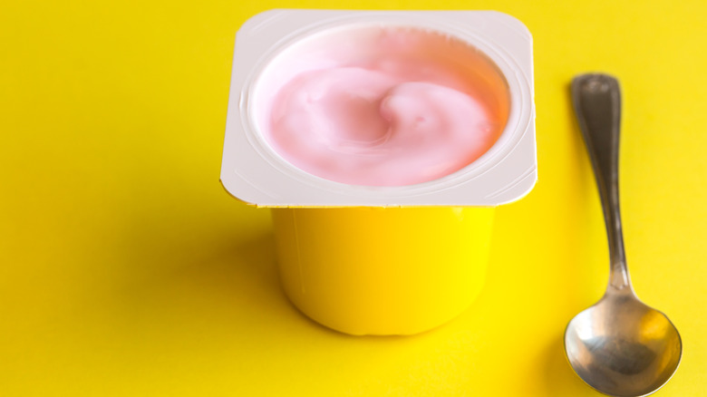 cup of pink yogurt with spoon