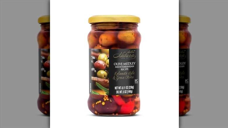 A jar of Della Natura Mediterranean Recipe Olive Medley on a white background.