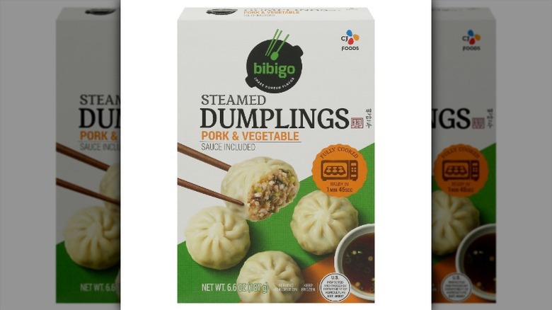 A box of Bibigo Steamed Pork & Vegetable Dumplings on a white background.