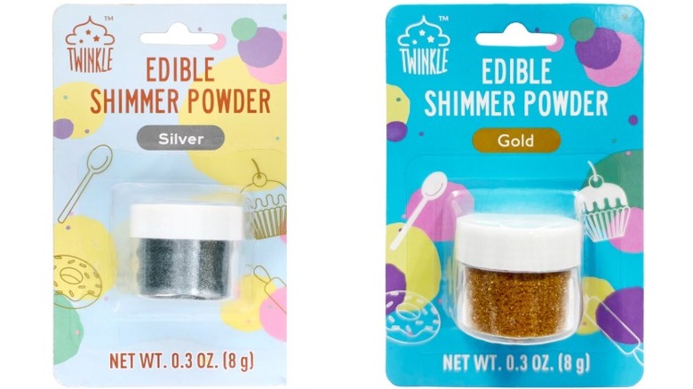 Packages of silver and gold Twinkle Edible Shimmer Powder on a white background.