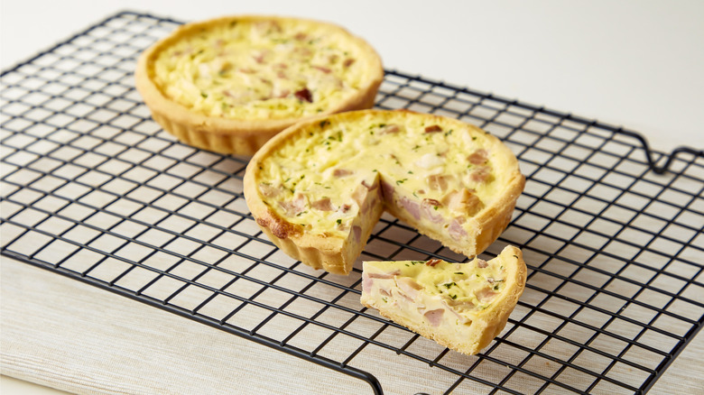 Ham and cheese quiches on baking rack