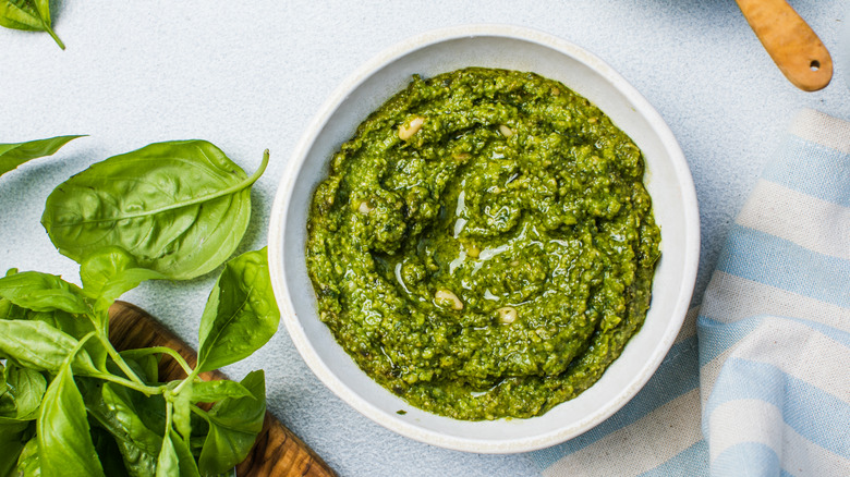 Bowl of pesto with fresh basil