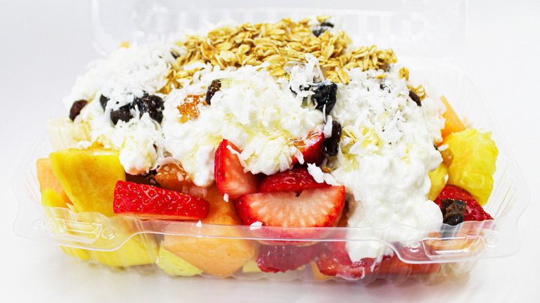 Mexican-style fruit and yogurt bowl known as bionicos in a clear plastic dish