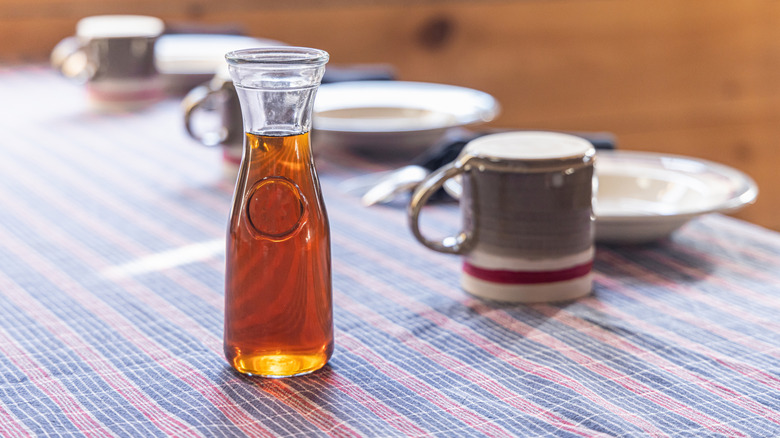 Bottle of maple syrup on table