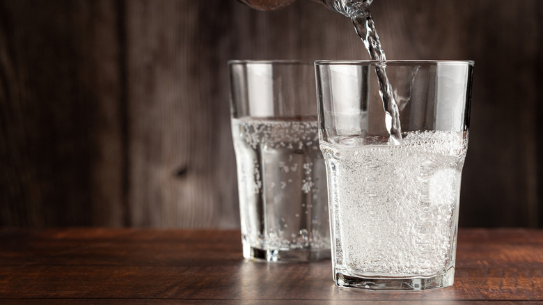 Pouring glasses of sparkling water
