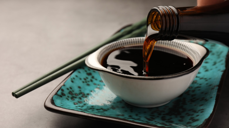 Pouring soy sauce into bowl