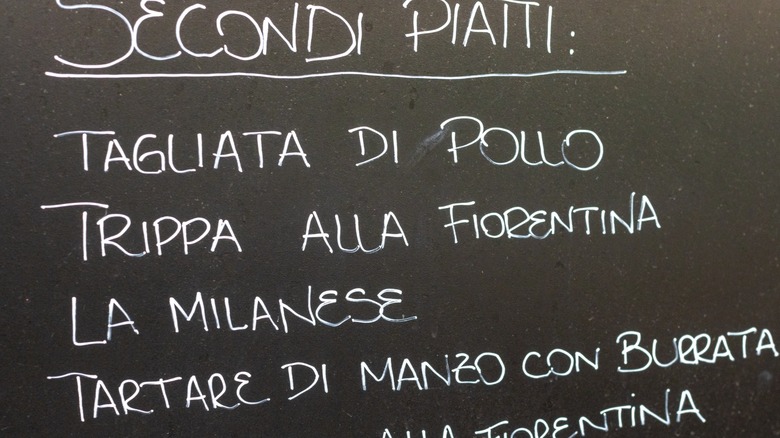 A chalkboard menu of secondi piatti at an Italian restaurant