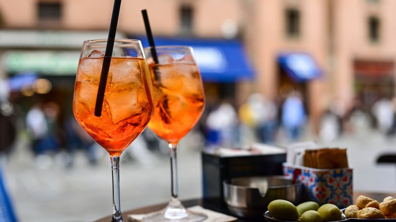 Aperol Spritz, olives and taralli snacks at an aperitivo bar in Italy