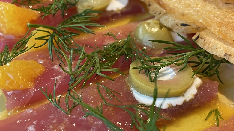 Thinly sliced tuna crudo with olive oil, citrus and herbs
