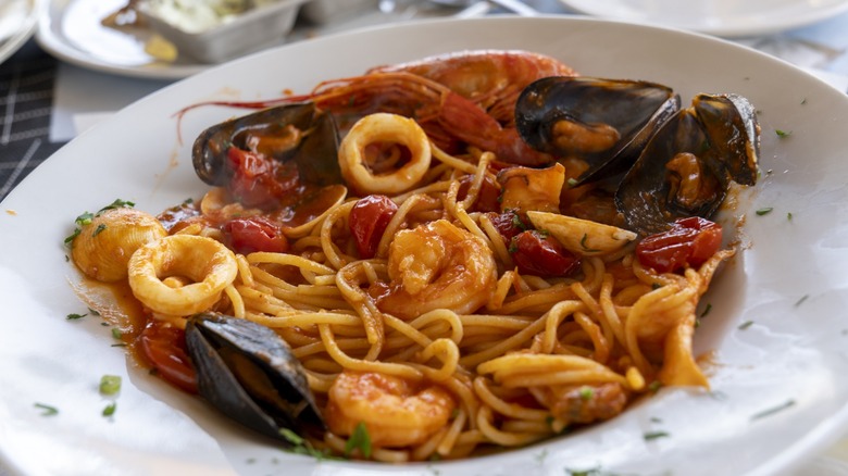 Frutti di mare seafood pasta in a dish with mussels, prawns, and shrimp