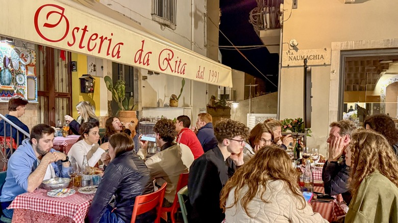 Diners seated at a Sicilian restaurant called Osteria da Rita