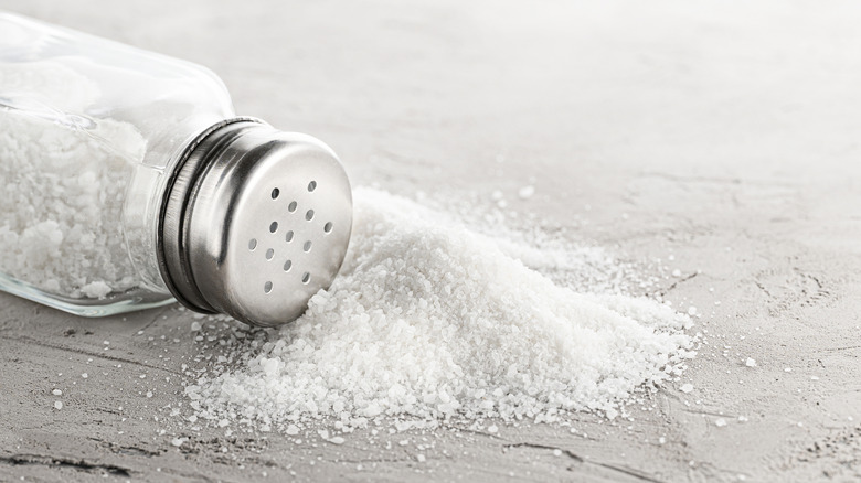 A salt shaker spilling salt