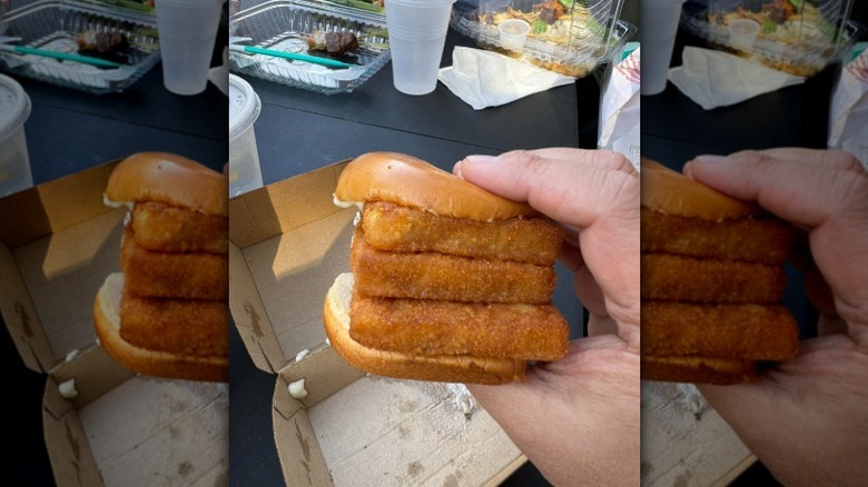 Hand holding a Triple Filet-O-Fish