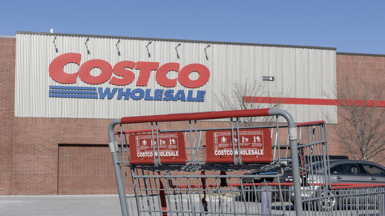 The outside of a Costco and a cart