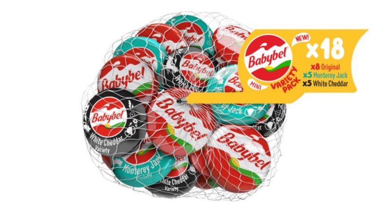 A variety pack of mini Babybel cheeses in a net bag isolated on a white background