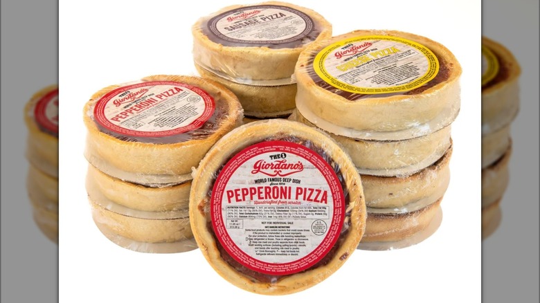 Stacks of assorted Giordano's deep dish pizzas