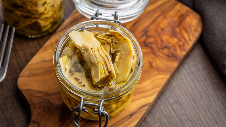 Open jar of artichokes in oil