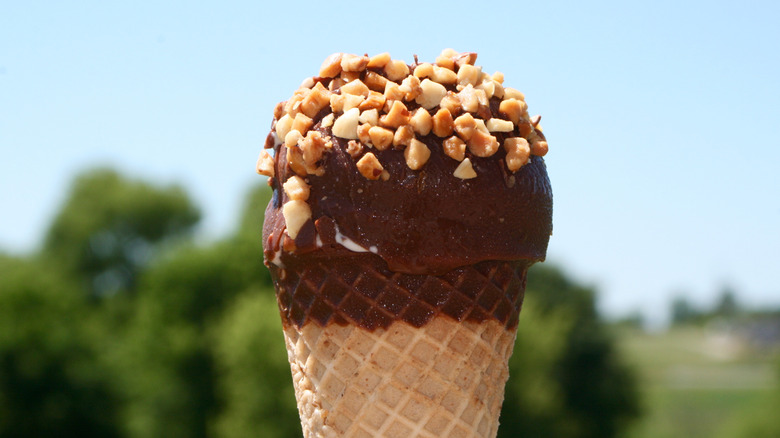 Close-up Drumstick ice cream cone with nuts on top