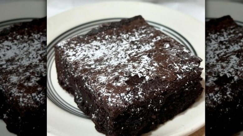 a brownie square covered in powdered sugar