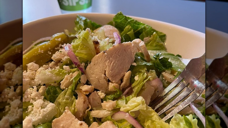 bowl of Greek salad with peppers, onions, and chicken