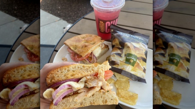 chicken frontega sandwich with chips and pink-colored drink