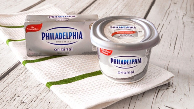 Containers of Philadelphia cream cheese.