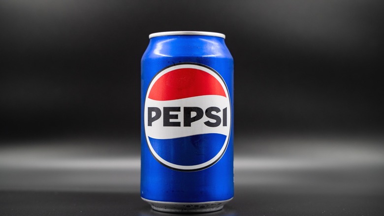 A can of Pepsi against a black background.