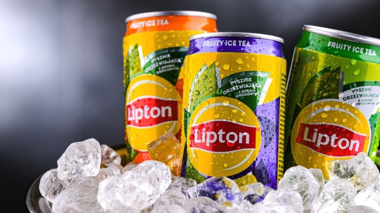 Cans of Lipton iced tea on ice.