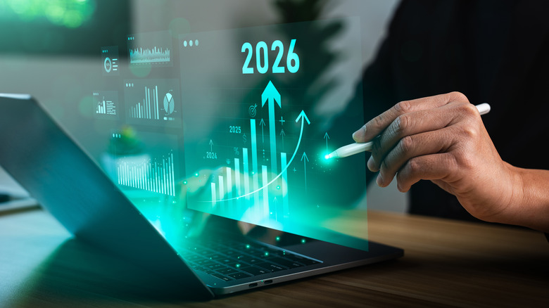 Man studying charts and graphs on a laptop.