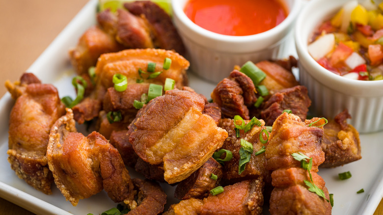 Crispy Fried Pork Belly Chicharrón with Dipping Sauces on a Plate