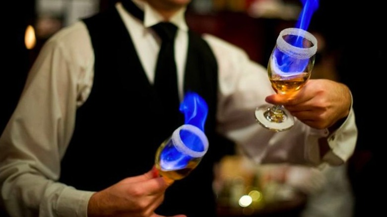 Bartender making flaming Spanish Coffee at Huber's