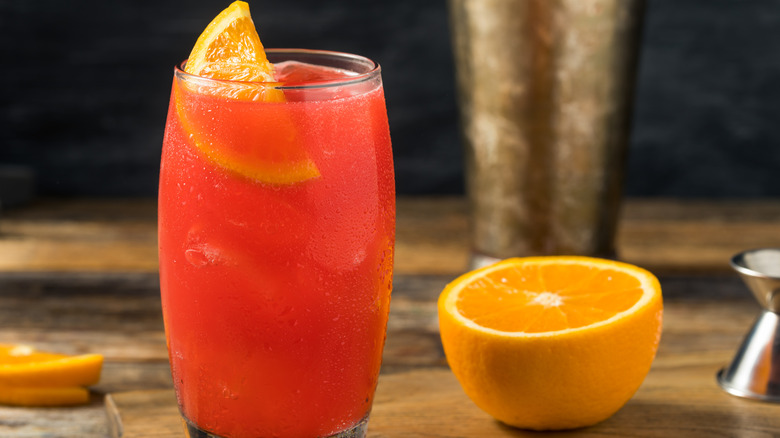 Alabama Slammer in glass with orange slice and half orange
