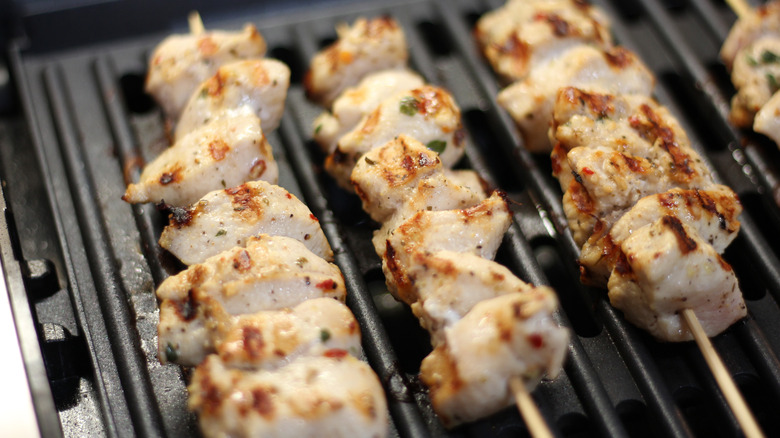 Chicken spiedies cooking on the grill