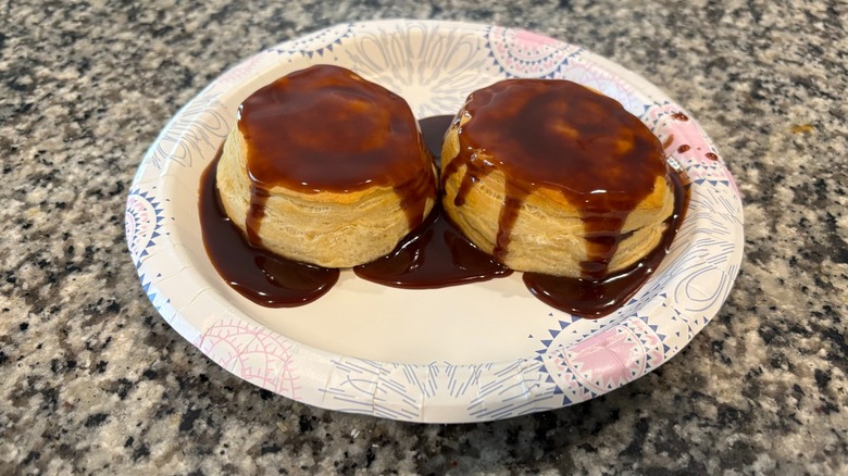 Chocolate gravy on two biscuits on paper plate