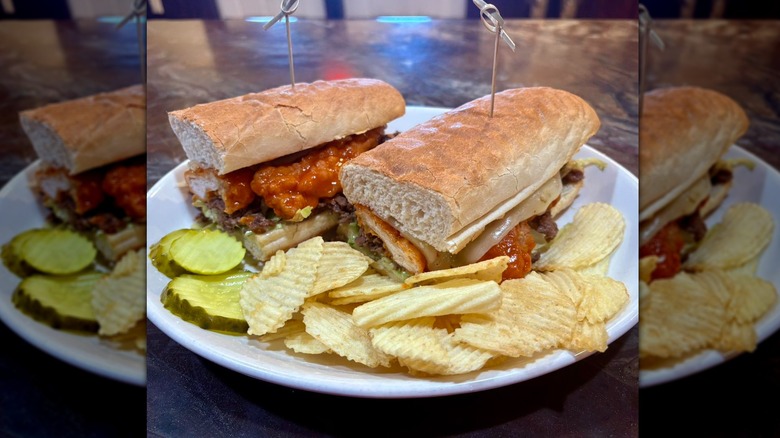 Stinger sub on plate with chips and pickles