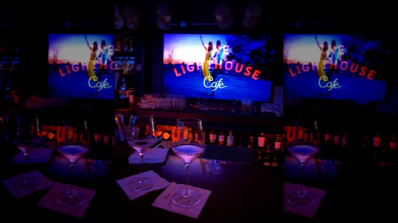 Two glasses of wine on bar in front of "La La Land" poster