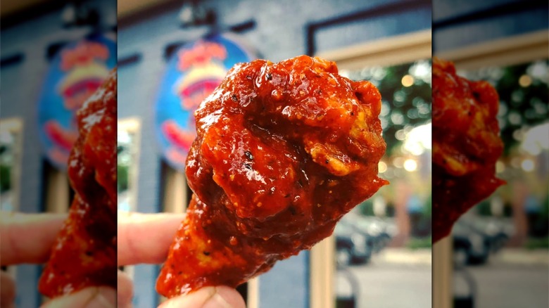 Spicy wing covered in sauce at Fire on the Mountain restaurant in Denver