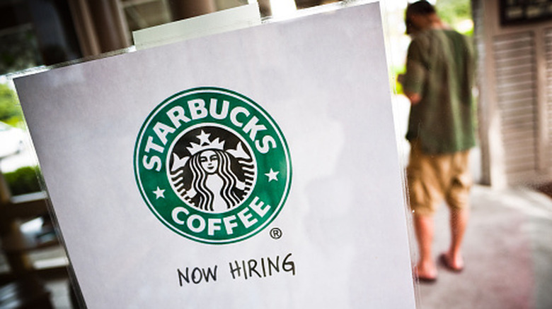 A help wanted sign at a Starbucks