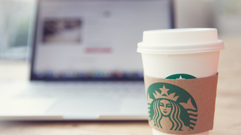 A Starbucks coffee in front of a laptop