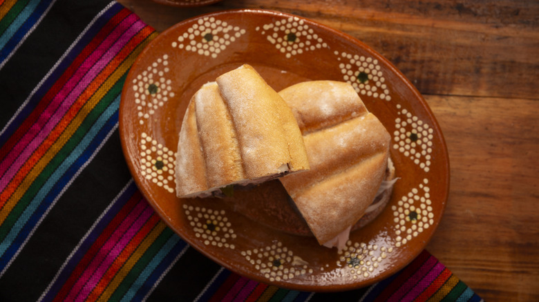 Torta al Jamon on Mexican plate with saltillo zarape