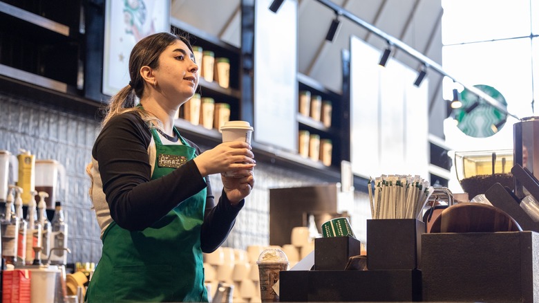 Starbucks barista serving drink