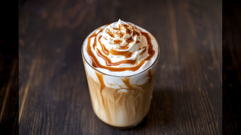 Caramel coffee drink with lots of caramel drizzle on top of whipped cream
