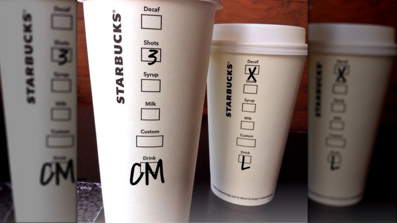 Two starbucks coffee drinks, one checked as Decaf