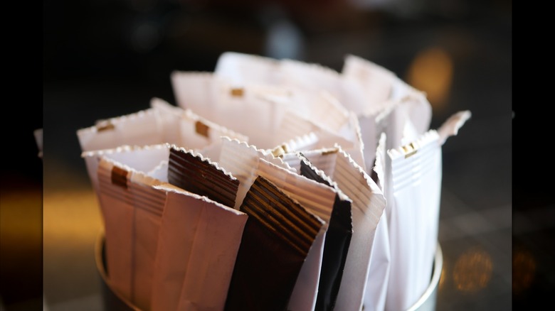 Canister of assorted sugar and sweetener packets