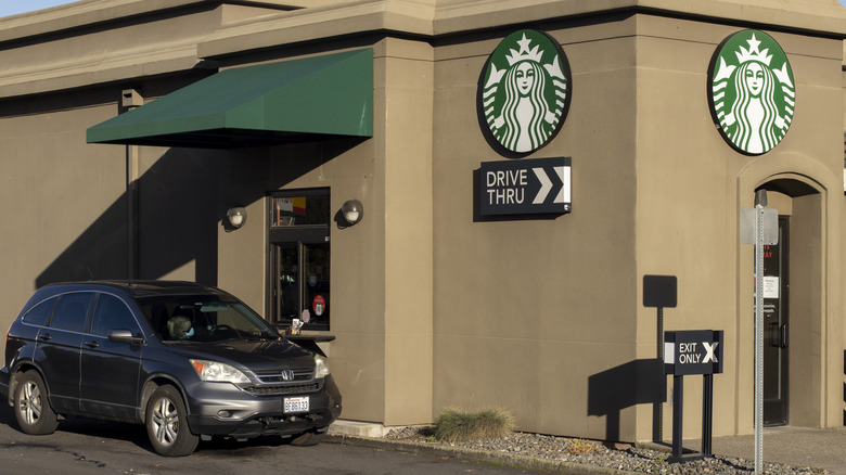 Car going through Drive Thru at Starbucks with Customer Driver placing an order