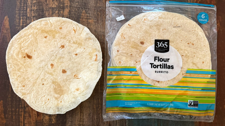 A package of 365 by Whole Foods Market Flour Tortillas next to a tortilla on a plate