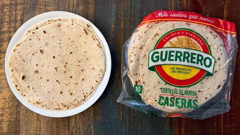 A package of Guerrero Caseras Flour Tortillas next to a tortilla on a plate