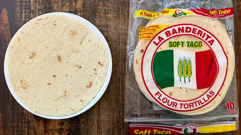 A package of La Banderita Flour Tortillas next to a tortilla on a plate