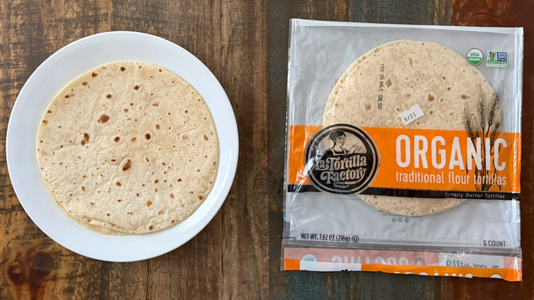 A package of La Tortilla Factory Organic Traditional Flour Tortillas next to a tortilla on a plate