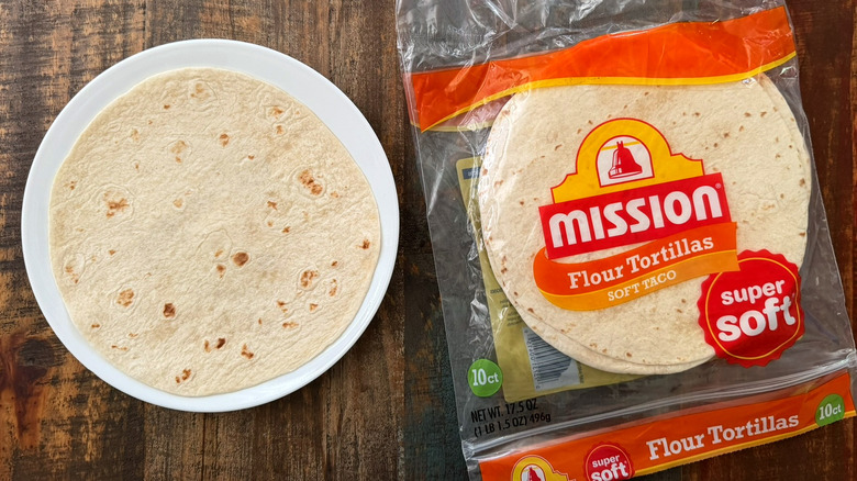 A package of Mission Flour Tortillas next to a tortilla on a plate